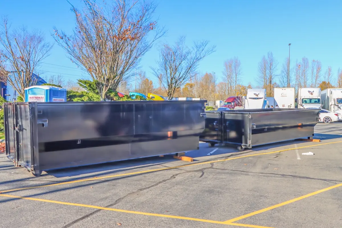 Professional dumpster rental service with roll-off container on residential driveway in Plattekill